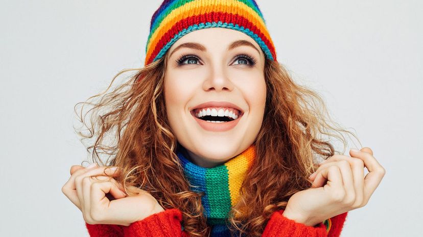 Woman in sweater and rainbow hat