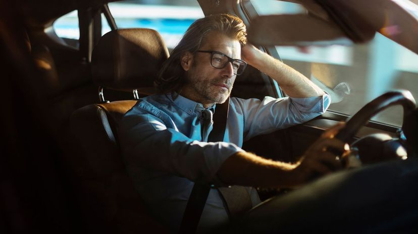 Boring man driving car