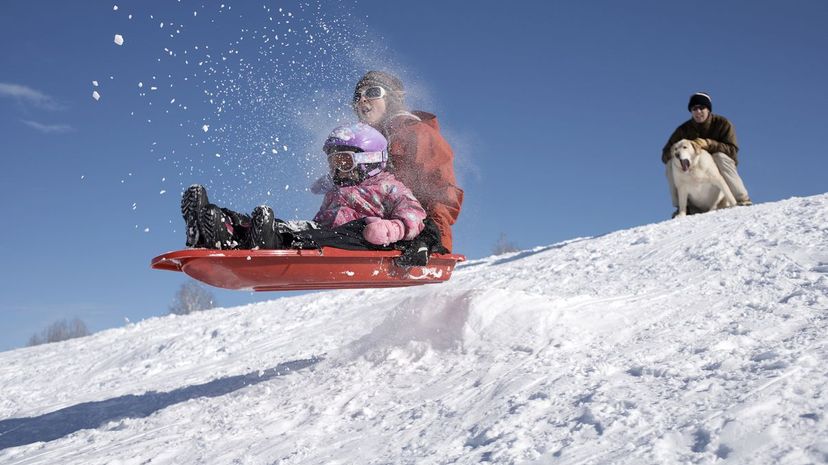 Mom and daughter sledding