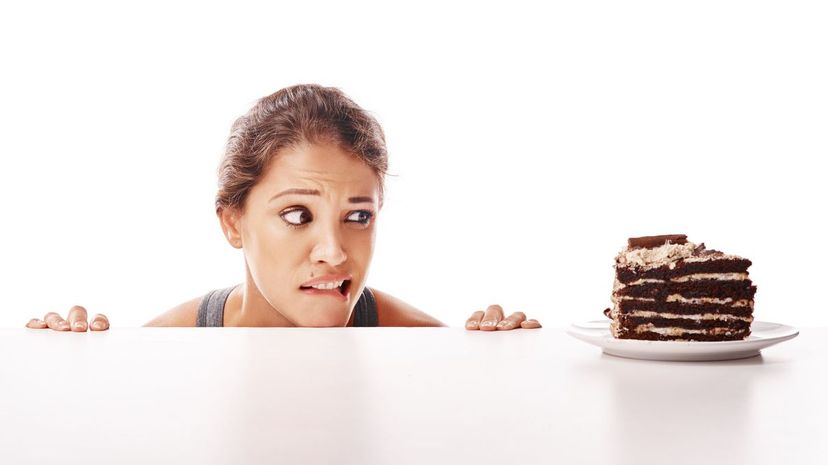 Woman being tempted by dessert