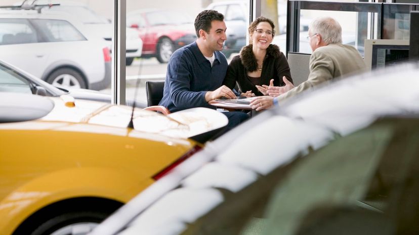 Couple with car salesman