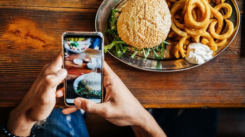 Man Talking Picture Of Burger