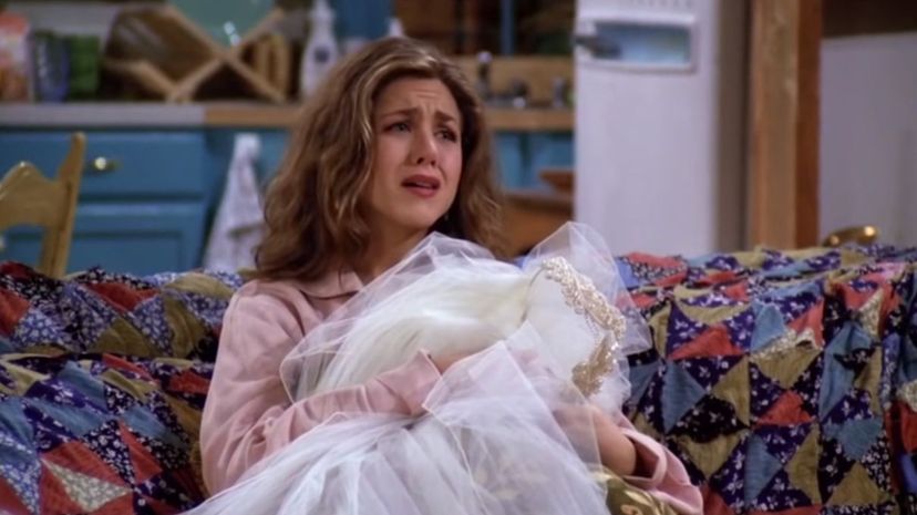 Rachel watching TV in tears