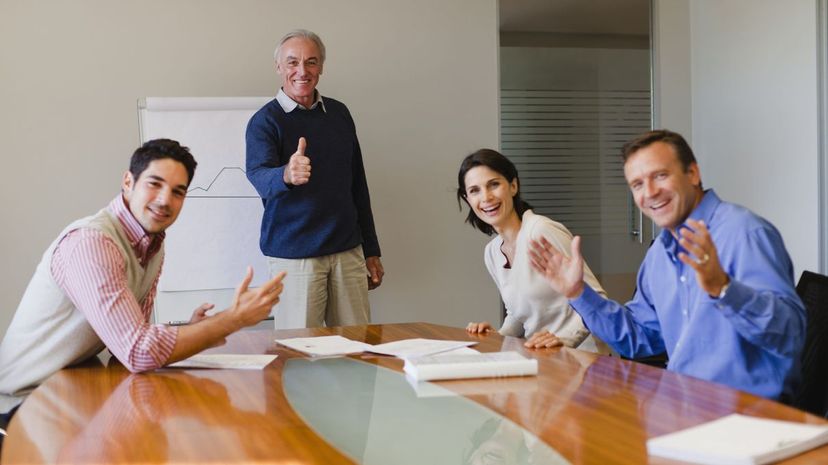 Business people cheering in meeting