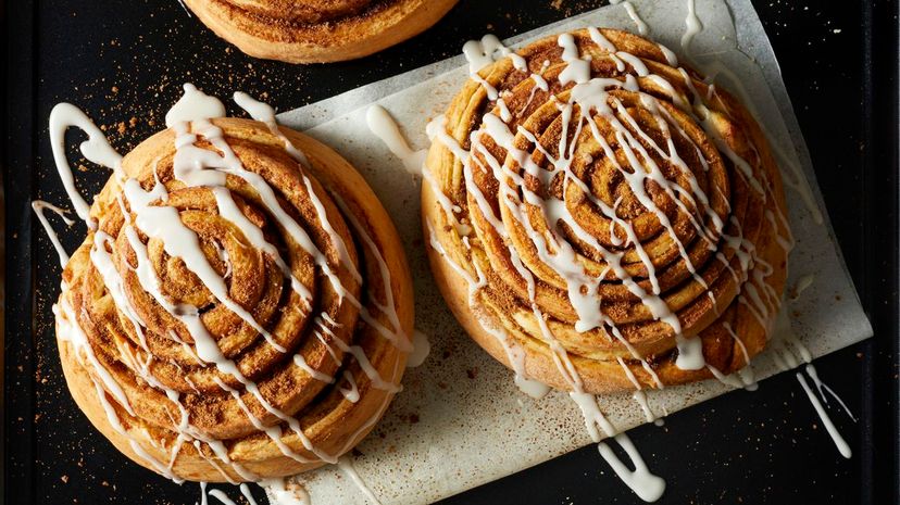 Cinnamon Rolls drizzled with icing on wax paper