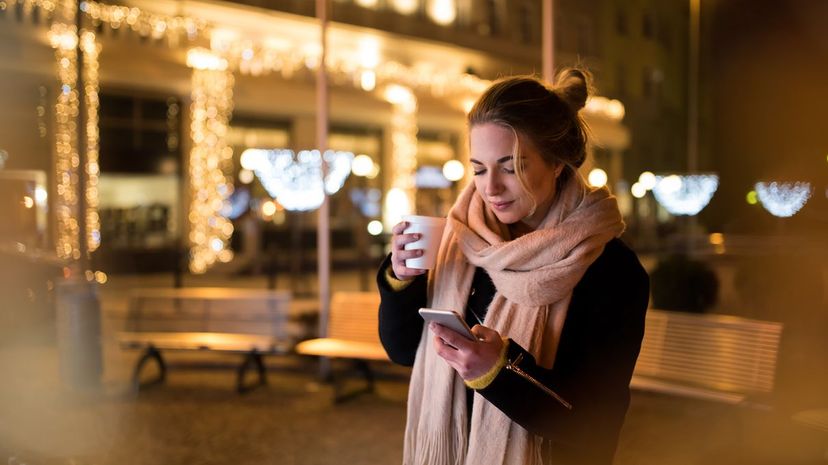 Woman using phone in winter