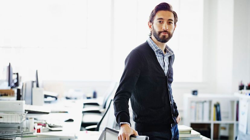 Smiling professional standing at workstation