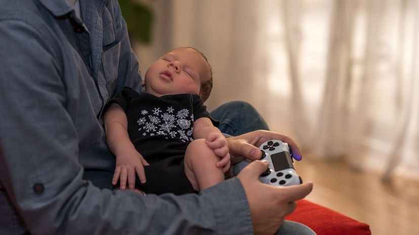 Holding video games and baby