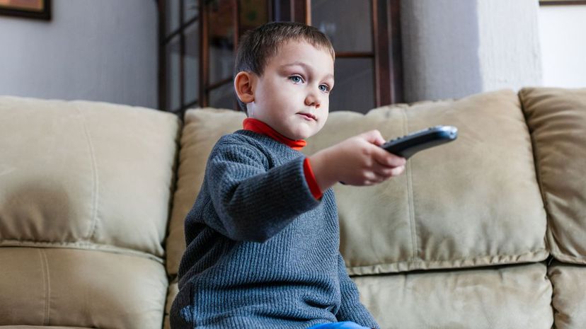 Toddler boy using remote control