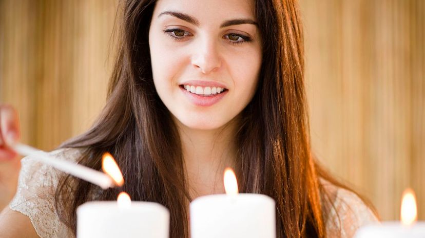 Young woman lighting candles