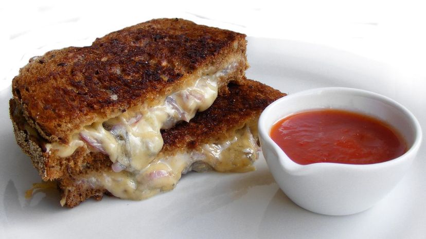 Grilled cheese sandwich served with a tomato and chili sauce