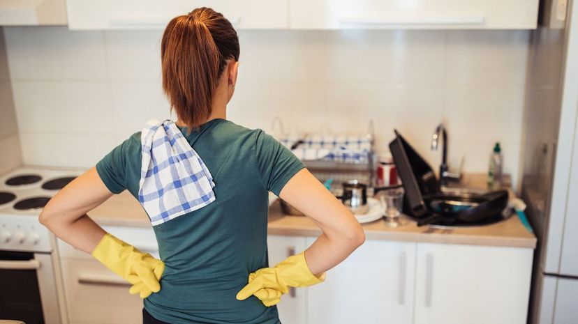 Woman looking at dirty dishes