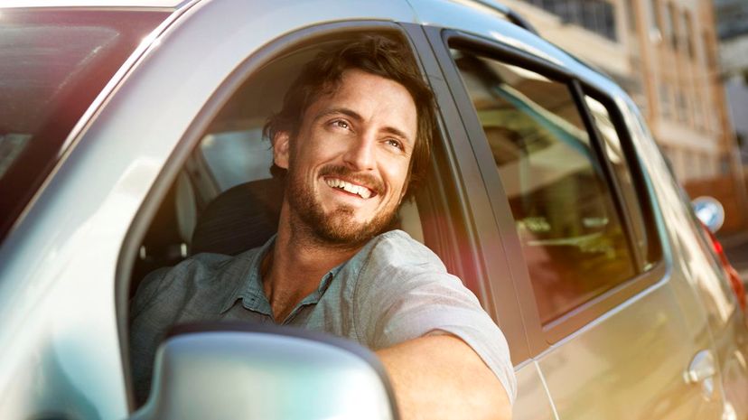 Young man looking out of car window