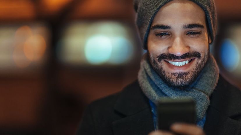 Man Smiling at Phone