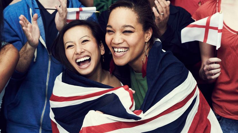 Two women wrapped in flag