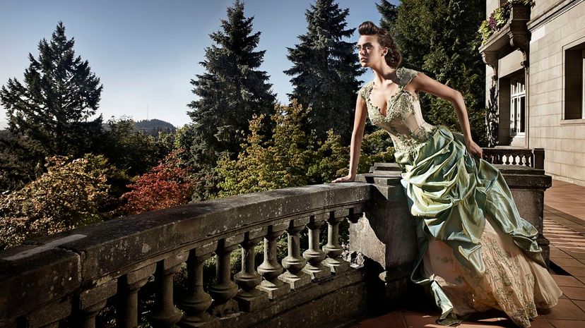 Beautiful Young Woman in Evening Gown on Mansion Balcony