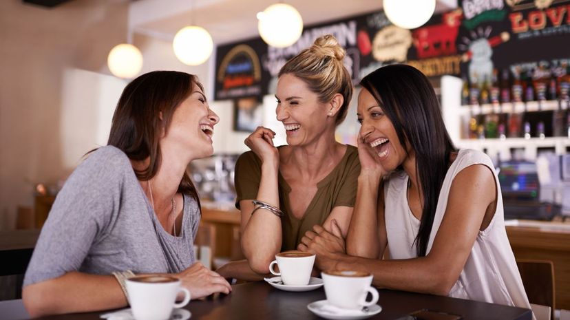 Three friends having fun at a coffee shop