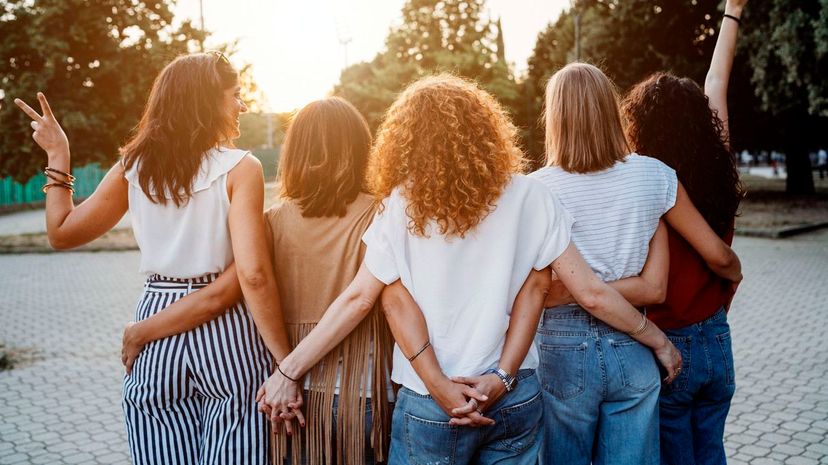 Group of women friends holding hands together