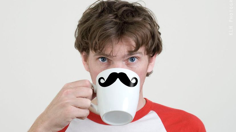 Man drinking coffee with handlebar moustache printed on it