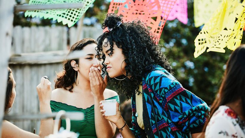 Woman whispering to friend