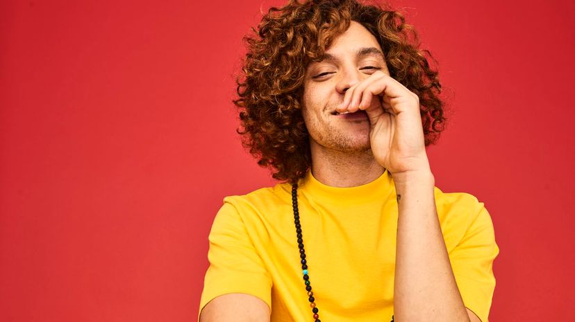 Colourful studio portrait of a young man laughing