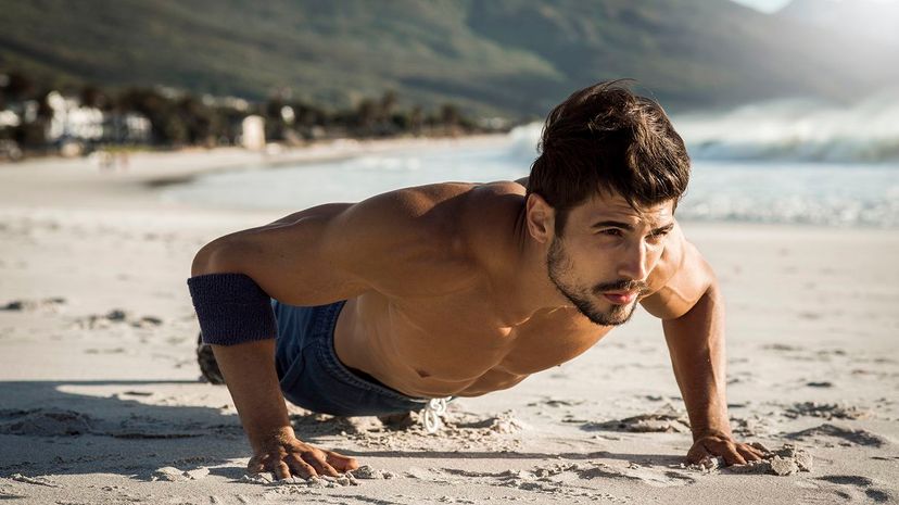 7 Man doing pushups on beach