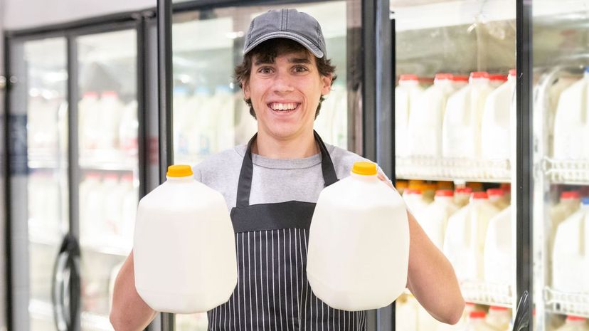 Man holding two gallons of milk