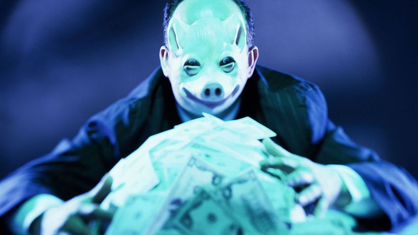 Man with pig mask on hoarding money