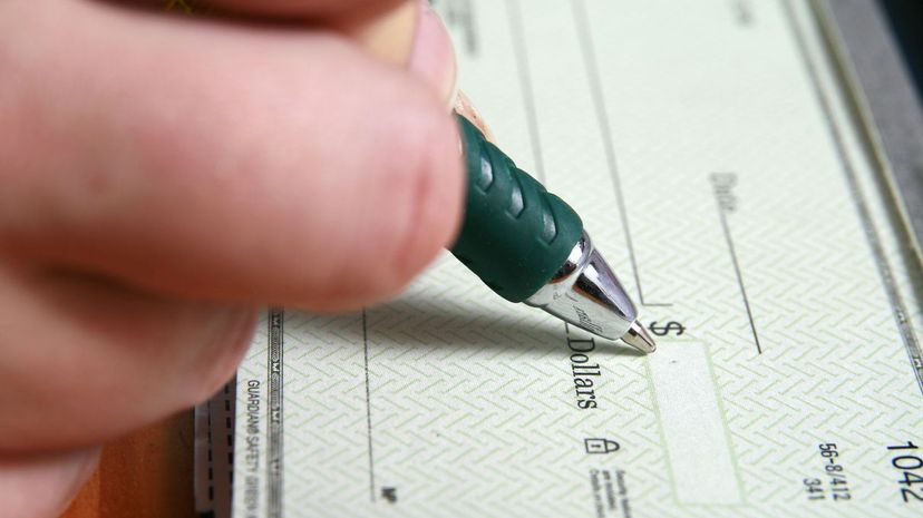 Filling in a blank check with a pen
