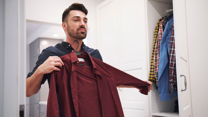 Man choosing shirt from closet