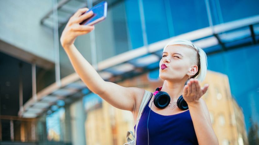 Blonde woman taking selfie