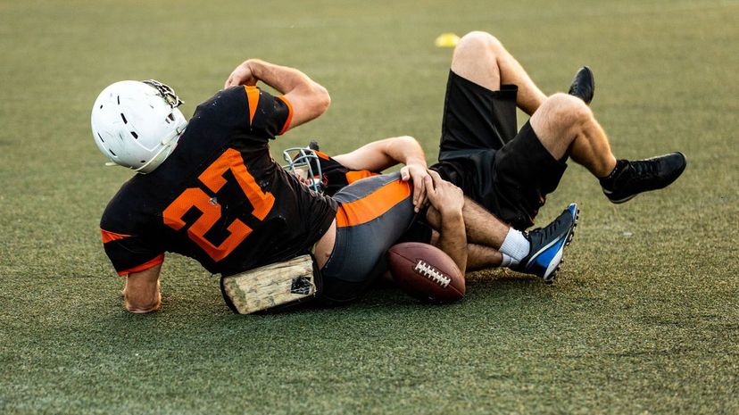 Football players wrestling on the ground