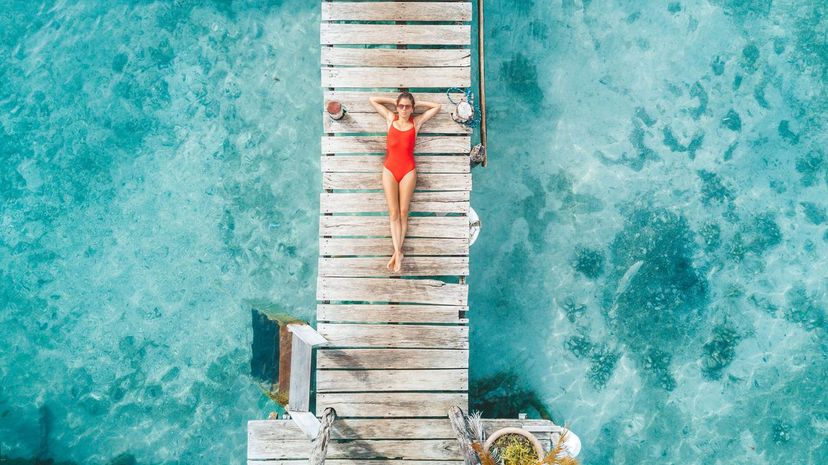 Womann relaxing in a water bungalow