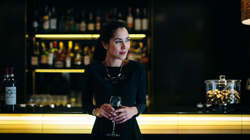 Woman at bar with glass of wine