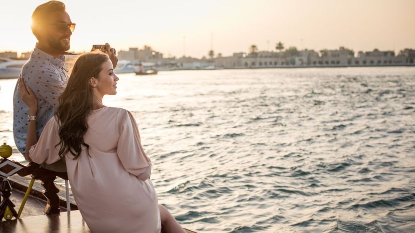 Romantic couple looking out from boat at Dubai marina