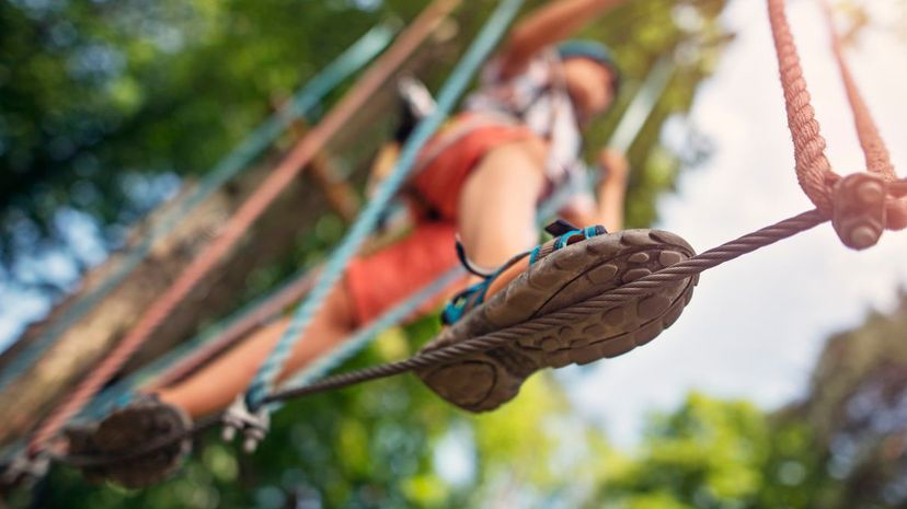 Little boy walking on line during ropes course