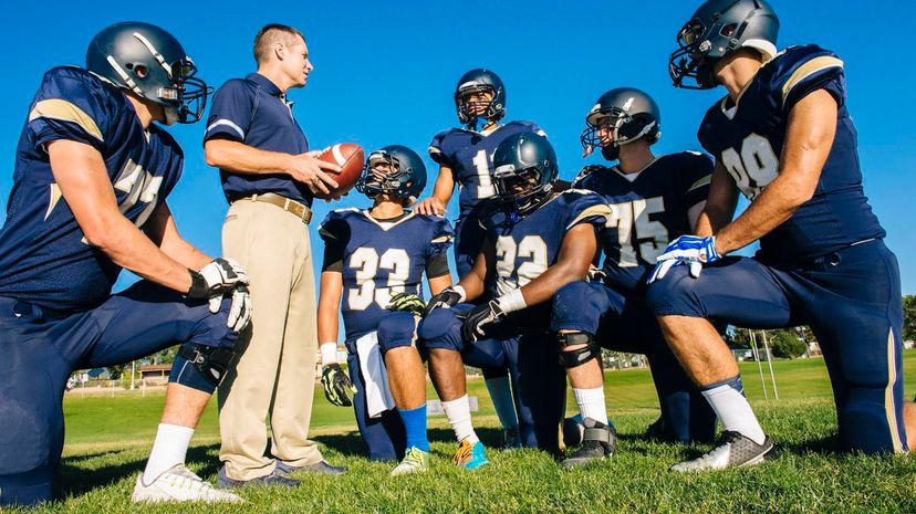 Coach training teenage and young male American football team