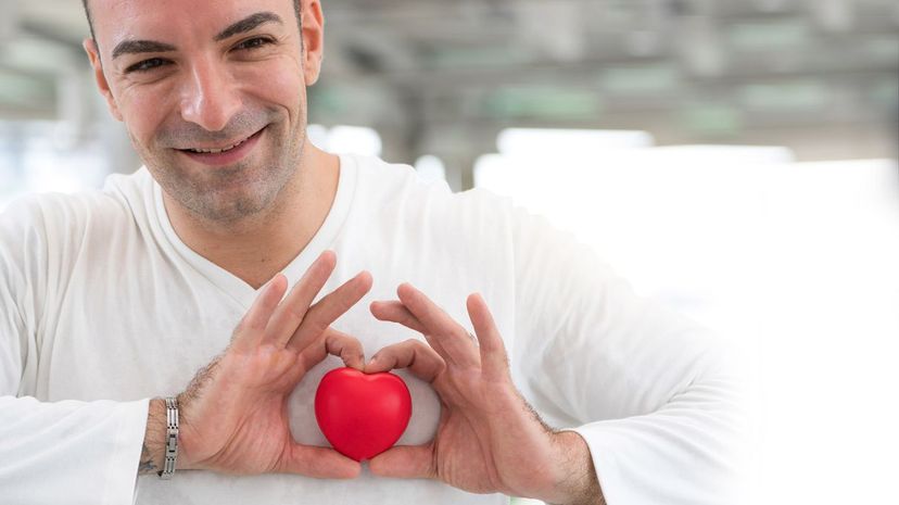 Man holding plastic heart