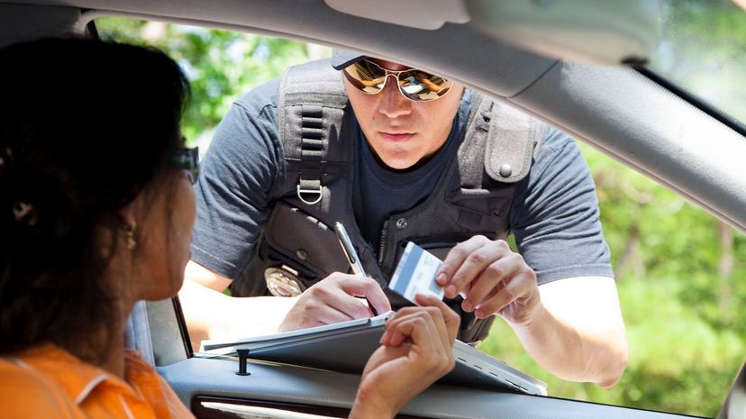 Policeman gives driver a traffic ticket