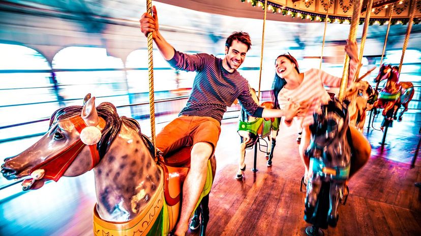 Couple riding merry-go-round