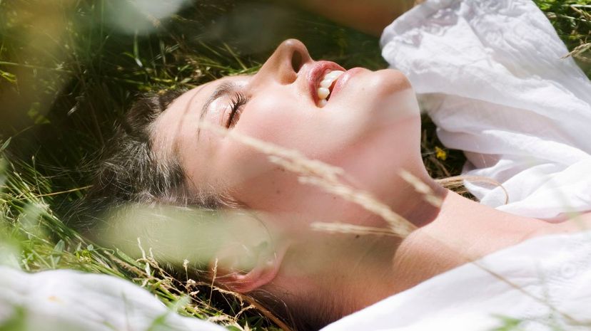 Young woman lying on a meadow