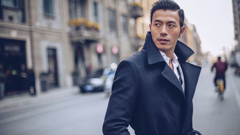 handsome asian man blue coat in city