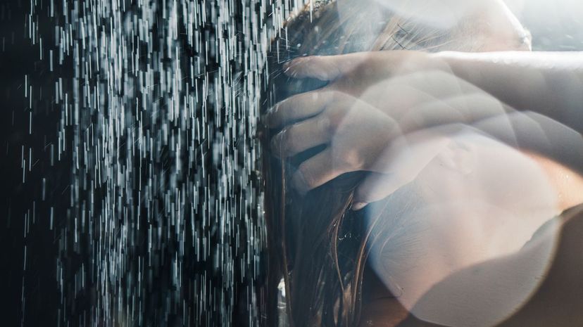 Woman taking a shower close up
