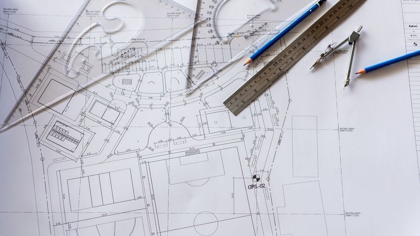Close-up of Architect engineer drawing plan on blueprint with architect equipment