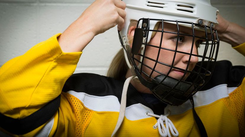 Ice Hockey Player Fastening Helmet