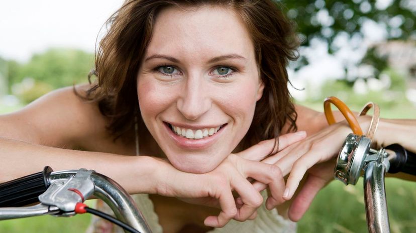 Woman leaning on bicycle