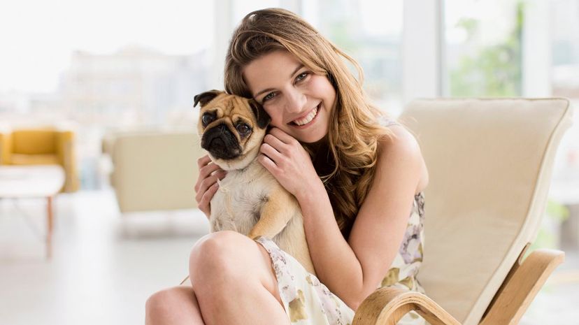 Woman Cuddling Pug