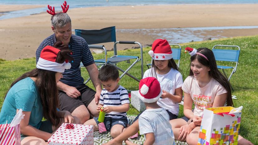 Family celebrate Christmas at beach in Auckland, New Zealand