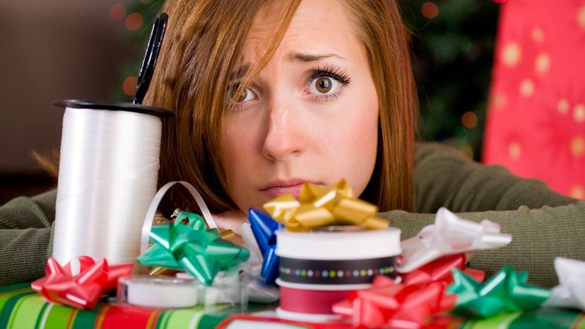 Young worried woman with Christmas presents