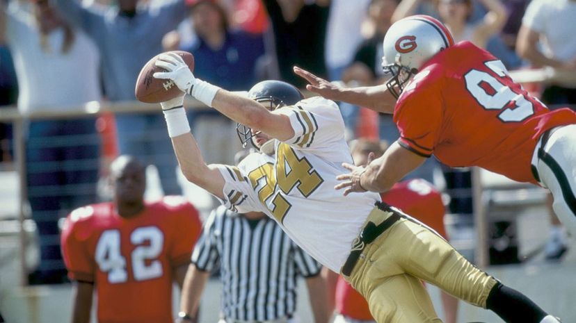 Receiver falling with ball as defense tackles